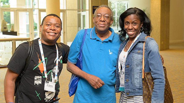 Three doctors posing for picture and smiling at the camera
